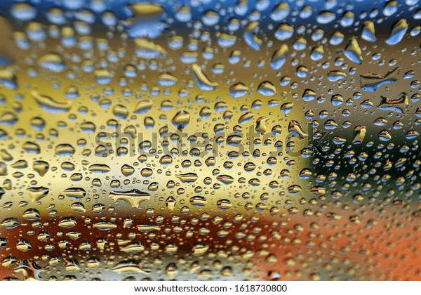 Water drop on glass mirror abstract background.\
Selective focus.