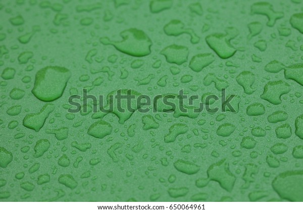 water drop on green paint\
surface