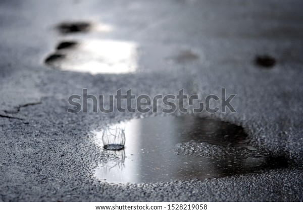 water drop on wet street in\
city