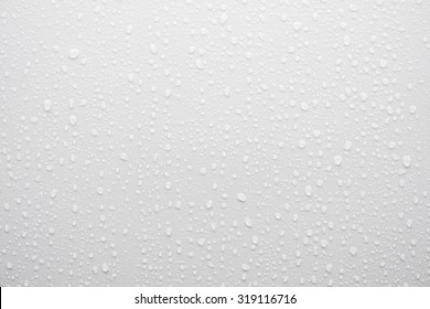 Water Drop On White Surface As Background