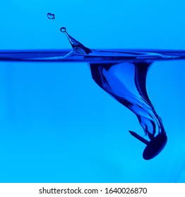 water drop splash in a glass blue colored.