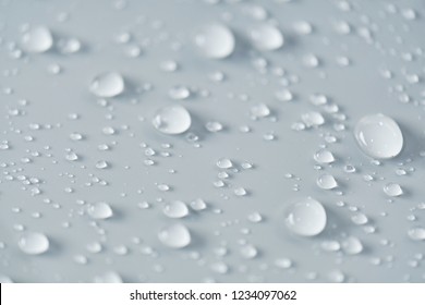 Water Droplet On The Car Hood. Water Beading After Rain Or Car Wash On White Shiny Paint Surface. Beading Created By Ceramic Coat Or Paint Sealant With High Surface Tension. Water Drop Backgroud.