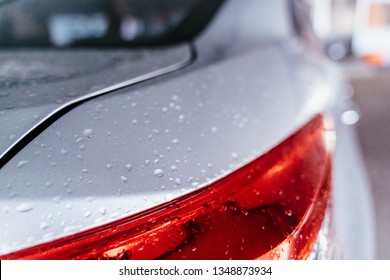 Water Droplet On The Car Hood. Water Beading After Rain Or Car Wash On White Shiny Paint Surface. Beading Created By Ceramic Coat Or Paint Sealant With High Surface Tension. Water Drop Backgroud.