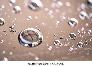 Water droplet on the car hood. Water beading after rain or car wash on black shiny paint surface. Beading created by ceramic coat or paint sealant with high surface tension. Water drop background.