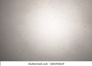 Water Droplet On Frosted Glass Or Wet Translucent Window From Rain On Rainy Season Or Water Drop And Splashes In Bathroom Or Shower Room With Warm White Light For Texture Background On Sepia Tone