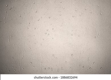 Water Droplet On Frosted Glass Or Wet Translucent Window From Rain On Rainy Season Or Water Drop And Splashes In Bathroom Wall Or Shower Room With Warm White Light And Sepia For Texture Background