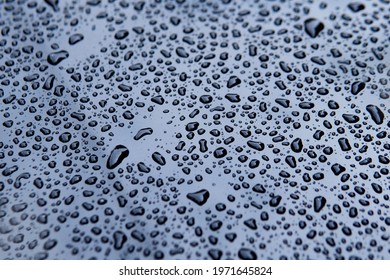 Water Droplets After Raining Fall On Front Light Blue Silver Color Car Bonnet Texture Background