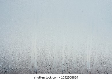 Water droplets condensation background of dew on glass, humidity and foggy blank. Outside , bad weather, rain