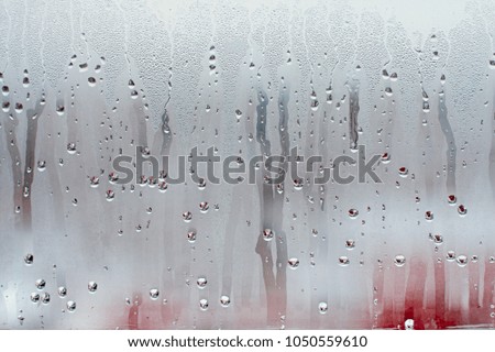 Similar – Drops on the window pane with reflection of the building opposite