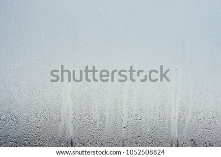 Water droplets condensation background of dew on glass, humidity and foggy blank. Outside , bad weather, rain