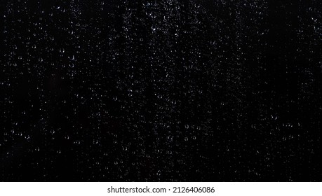  Water droplets on the black glass.                       