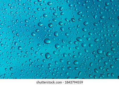 Water droplets on blue stainless steel. Background, wallpaper, patter.