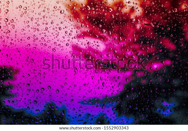 Water droplets on colorful background.\
Close up water droplets on car mirror.soft\
focus.