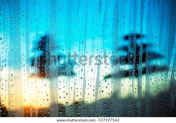 Water\
droplets on glass with morning light in\
winter.