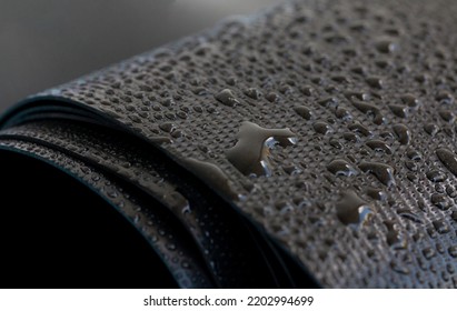 Water droplets on the rubber membrane. Waterproofing...  Close-up selective focus area. - Shutterstock ID 2202994699