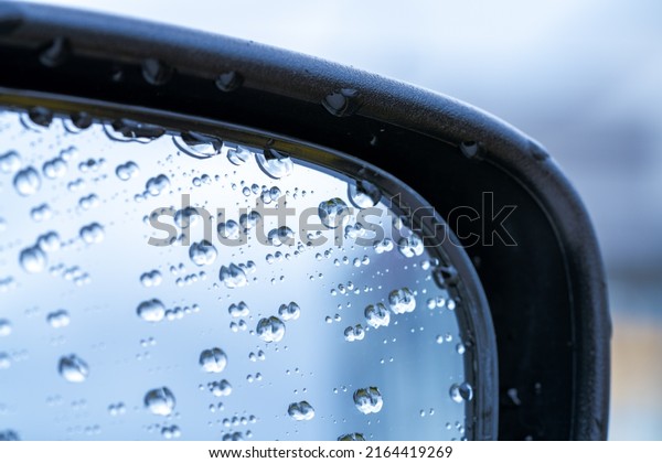 Water droplets\
on the side mirrors of the\
car.