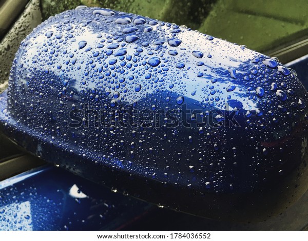 Water drops at blue car paint. Polishing and\
detailing cars