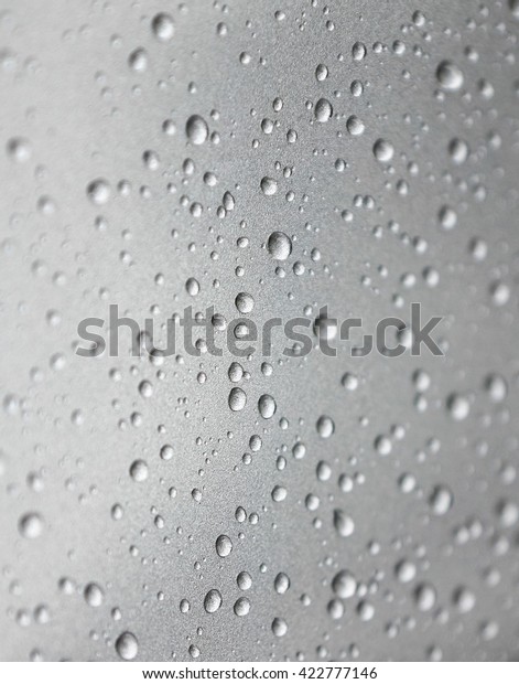 Water\
drops collect on top of metallic car\
surface\
