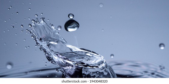 Water drops collision on a blue background. Abstract clear nature background