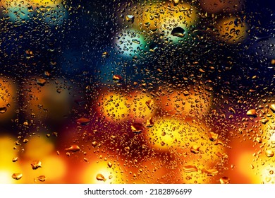 Water drops and condensation in a window glass. Abstract background niglt light. - Shutterstock ID 2182896699