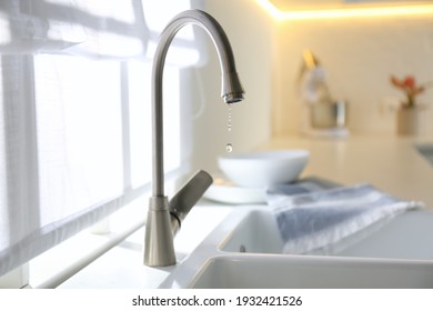 Water Drops Falling Down From Tap In Kitchen