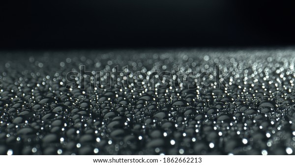 Water drops\
with Light reflection on black background. Drops on glossy surface.\
Abstract wet surface. Point of\
View.