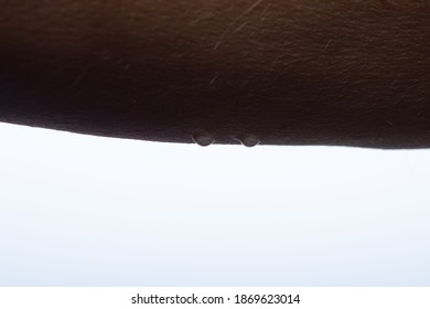 Water Drops On Arm African Dark Brown Skin, Close Up Of Wet Human Skin Texture With White Background. High Quality Photo