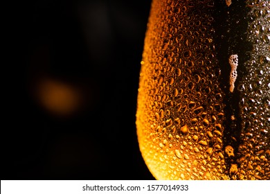 Water Drops On The Beer Glass Over A Black Background. Beer. Cold Craft Light Beer In A Glass With Water Drops.