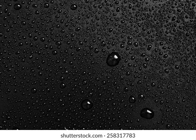 Water Drops On A Black Plastic Surface