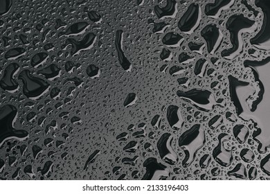 Water drops on black surface background. Raindrops for overlaying on window, concept of autumn weather,