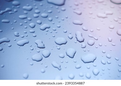 water drops on blue background. close up view. rain drops on a car. car paint protection concept. paint protection film for cars. - Shutterstock ID 2393354887