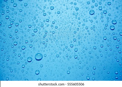 Water Drops On Blue Background. - Shutterstock ID 555605506