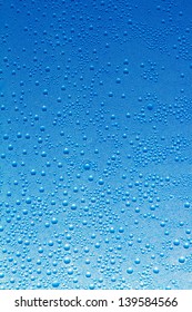 Water drops on a blue glass background