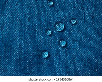 Water Drops On Blue Waterproof Fabric.