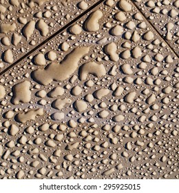 water drops on brown ceramic tile