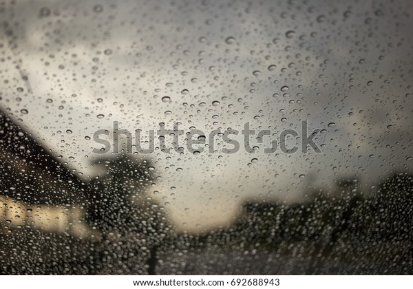 Water drops\
on car glass at Asian railway\
station
