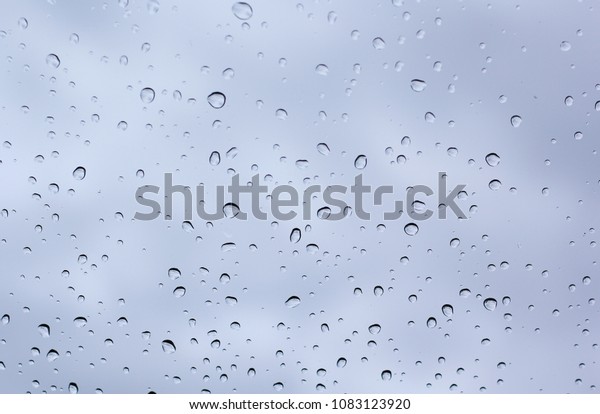 Water drops on car glass.rain drops on clear\
window (rainy season)