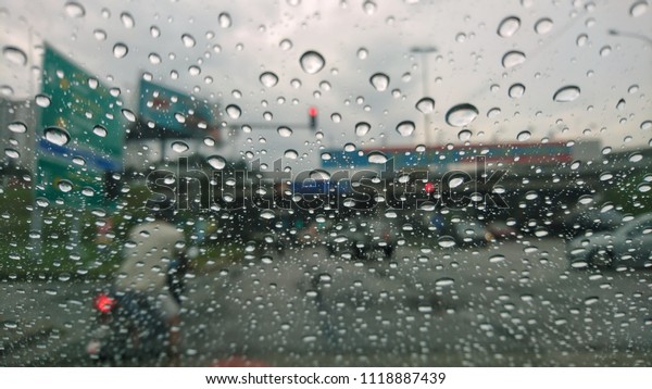 Water drops on a car mirror. View
through a car window and selective focus on the raindrop.
