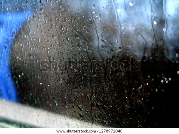 Water Drops On A Car\
Window In A Rainy Day