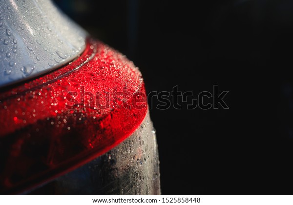 Water drops on cars, rain on\
cars, luxury car details,Rear light of a car with a black\
background	
