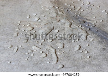 Water drops on concrete floor. Close up of water drops on cement ground.