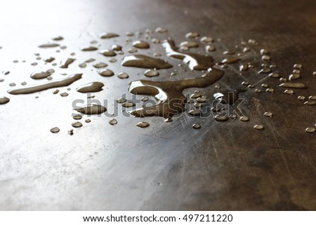 Water drops on concrete floor. Close up of water droplets on cement ground.