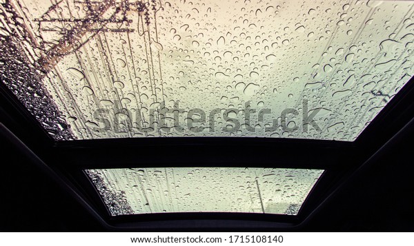 Water\
drops on glass of car sunroof with copy space.\
