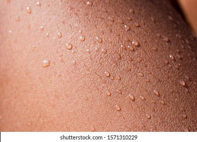 Water drops on human skin in macro view - Shutterstock ID 1571310229