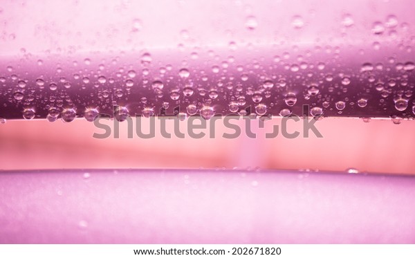 Water\
drops on metal surface texture in violet tone \
