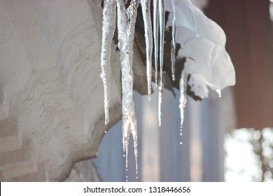 Water drops on the roof. icicles melt under influence of warm air and sun. Spring influence in the world. Modifying the pores of the years. The sun's rays change aggregate state of ice to water