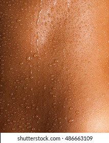 Water drops on the skin of a young woman.