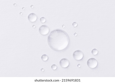 Water drops on white background. Abstract drops of gel. Face serum cosmetics. 