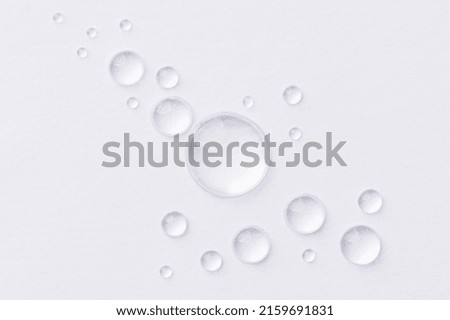 Water drops on white background. Abstract drops of gel. Face serum cosmetics. 