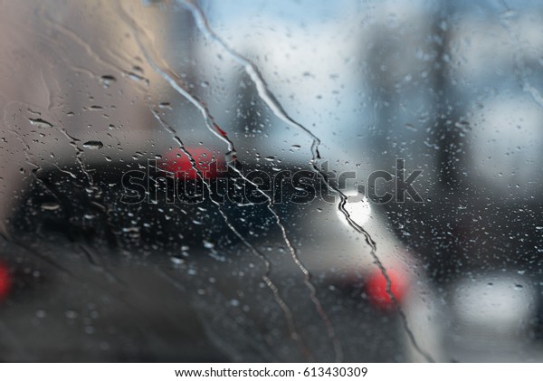 Water drops on window. Car\
is ahead.